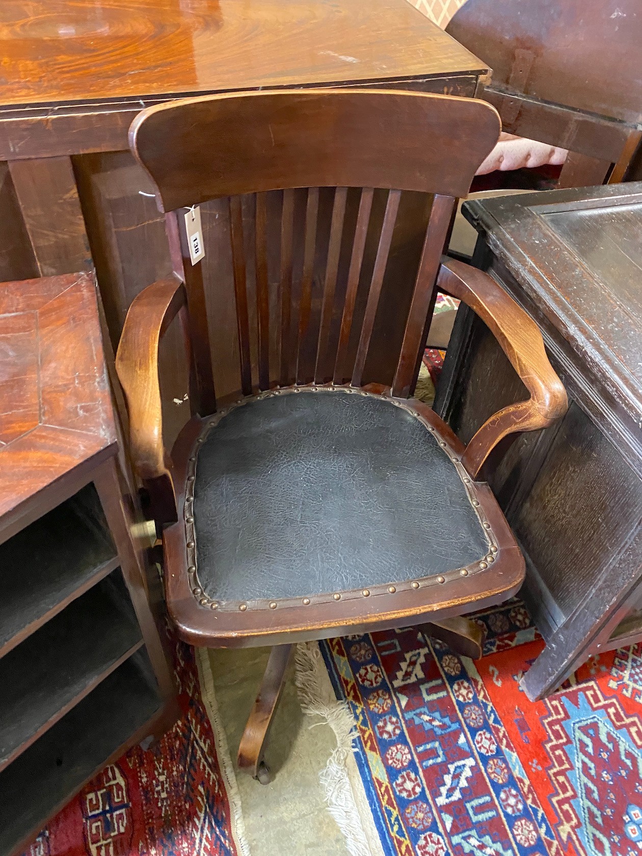 An early 20th century beech swivel desk chair, width 56cm, depth 48cm, height 92cm